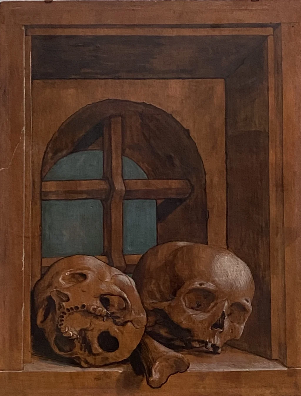 Two skulls in a window niche