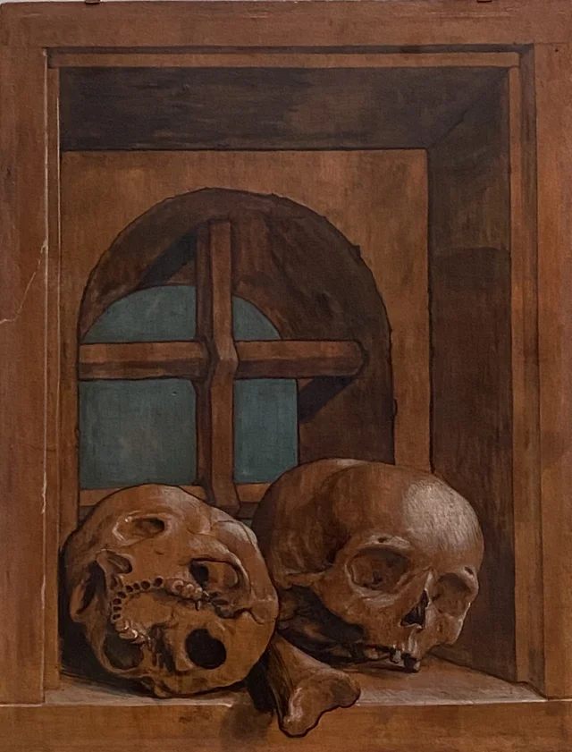 Two skulls in a window niche