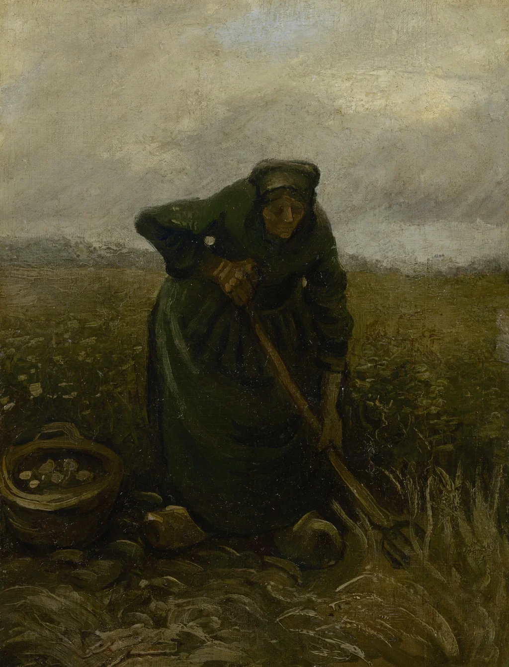 Femme ramassant des pommes de terre