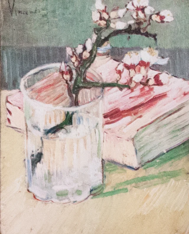 Blossoming Almond Branch in a Glass with a Book
