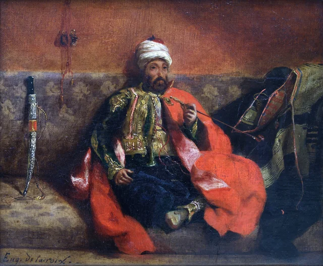 Turc fumant, assis sur un divan